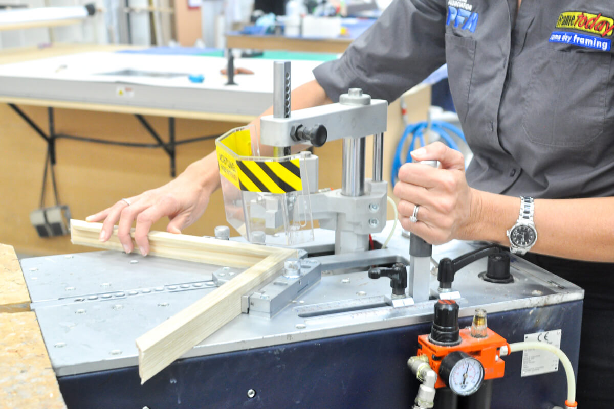 A Frame Today framing consultant joining a custom picture frame in-store