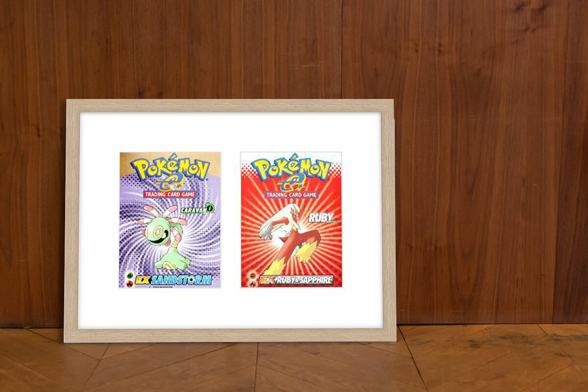 Pair of Pokemon collectible cards in double opening picture frame