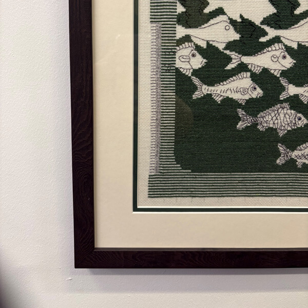 Corner detail of stretched and framed needlework